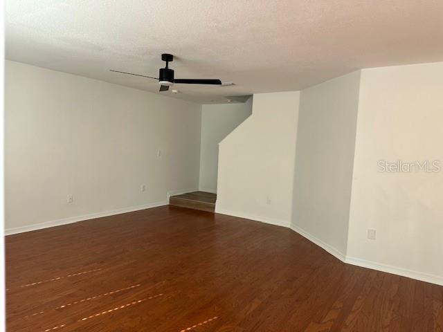 An empty room features wood-look flooring, white walls, and a ceiling fan — 10931 KEYS GATE DRIVE, RIVERVIEW, FL