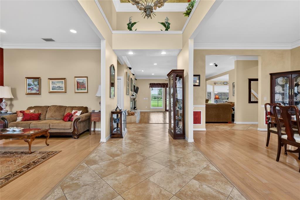 A tiled entryway leads into a living room with hardwood floors and a dining area — 1920 EDGEWATER DRIVE, MOUNT DORA, FL