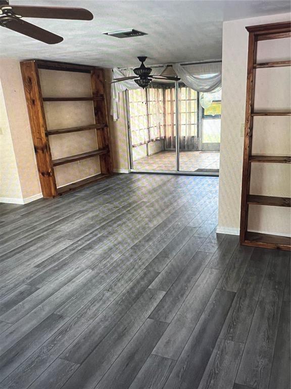 A kitchen features white appliances, light-colored cabinetry, a tiled floor, and a window with curtains — 7202 GULF HIGHLANDS DRIVE, PORT RICHEY, FL