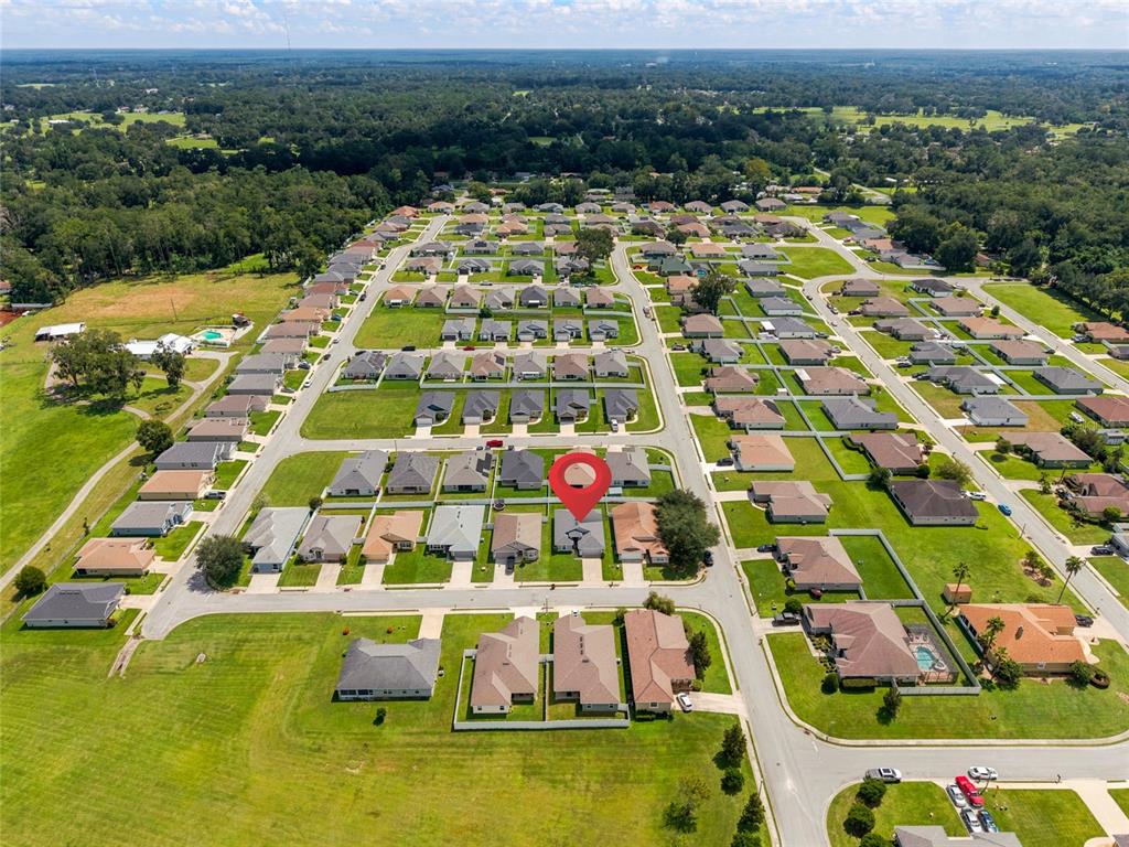An aerial view shows a suburban neighborhood with a red location pin on a house — 4427 NW 2ND COURT, OCALA, FL