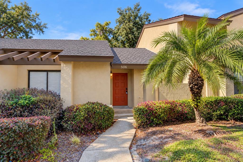 A tan stucco building with a red tile roof and a red front door — 506 CLUB DRIVE, WINTER SPRINGS, FL