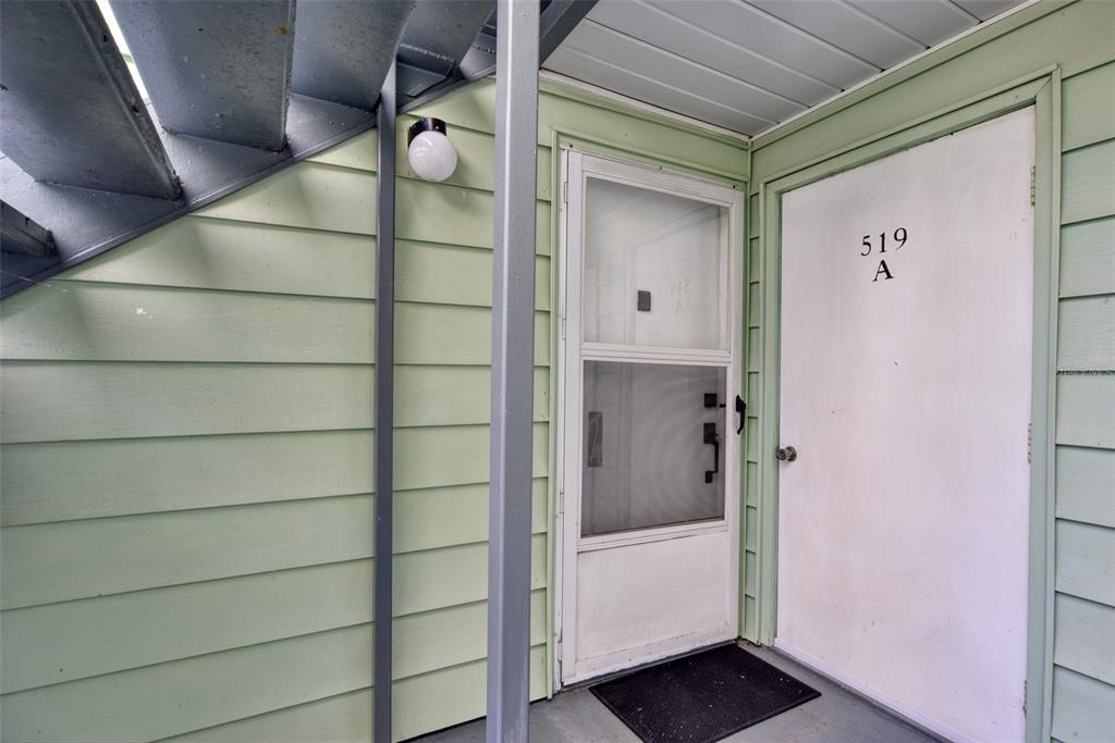 A white door labeled 519 A sits next to a storm door on a porch — 519 MIDWAY DRIVE UNIT A, OCALA, FL