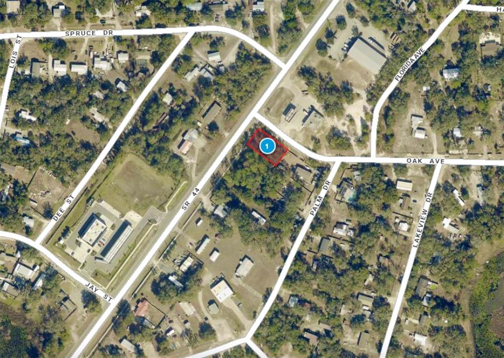 An aerial map view shows a highlighted rectangular lot located near a road intersection — LOT 14 STATE ROAD 44, EUSTIS, FL
