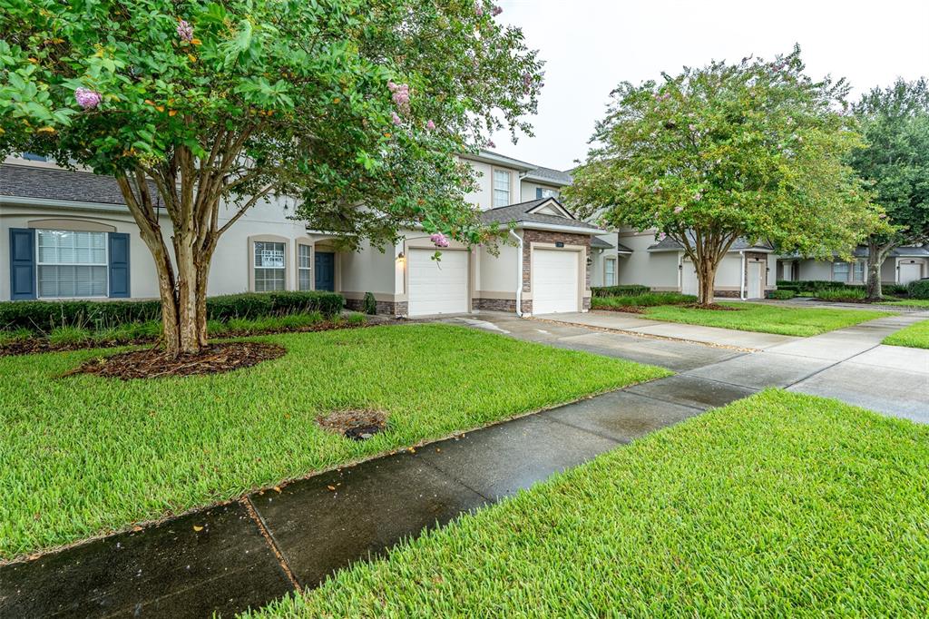 An aerial view shows a multi-unit residential building with a shingled roof and lawn — 332 WOODED CROSSING CIRCLE, ST AUGUSTINE, FL