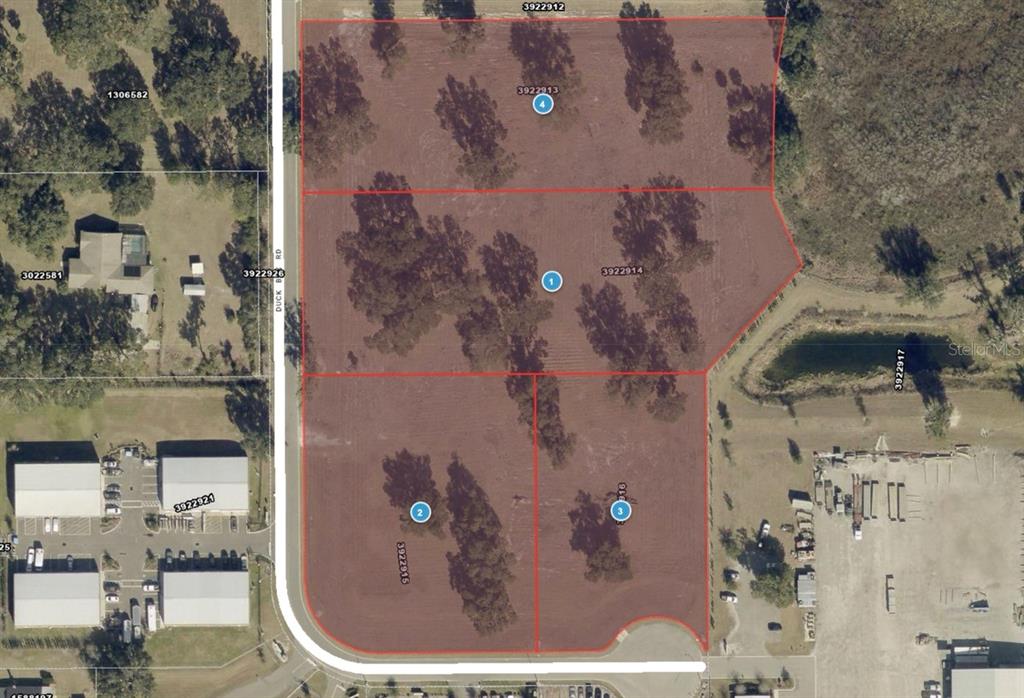 This aerial map shows four adjacent parcels of land outlined in red — 1060 DUCK BOX ROAD, UMATILLA, FL