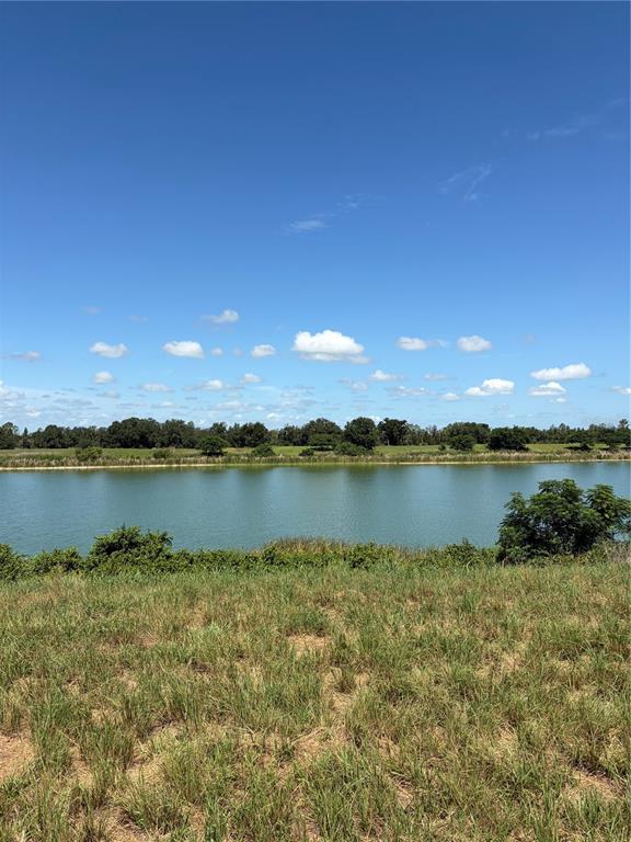 An aerial view shows a green lake bordered by grassy lots with scattered trees — 10349 COUNTY ROAD 555, FORT MEADE, FL