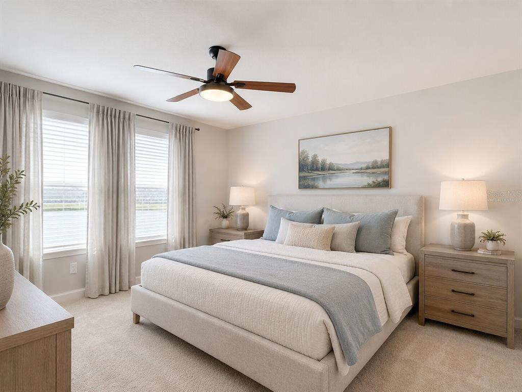 A bedroom features a bed with blue accents, two nightstands, and a ceiling fan — 2376 AUDUBON PRESERVE LANE, LUTZ, FL