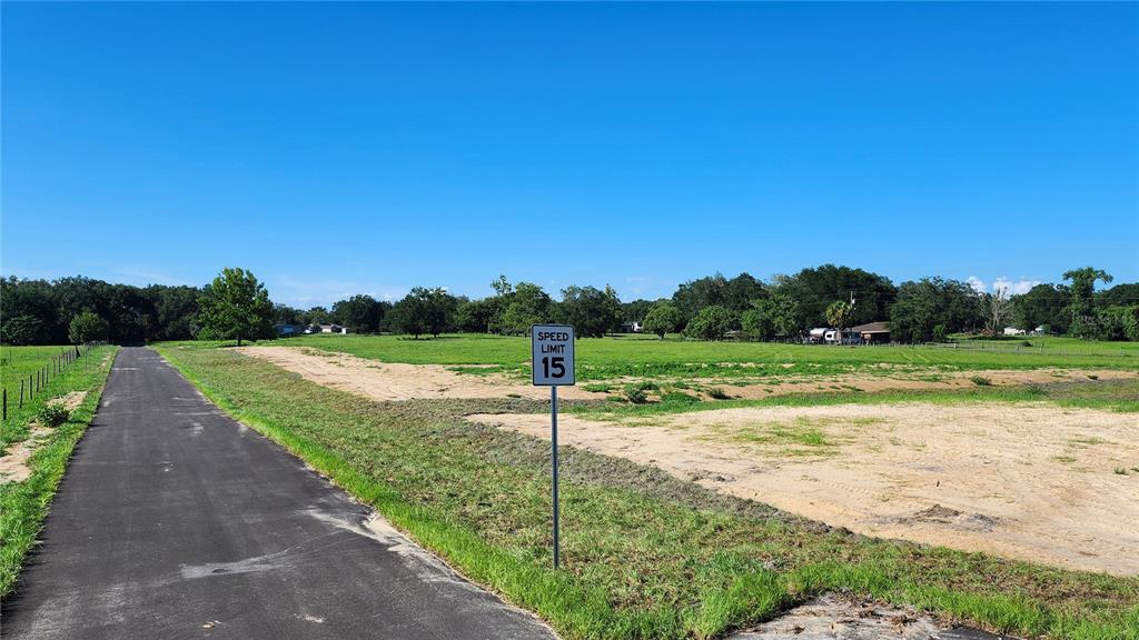 A dirt construction site features tire tracks leading toward a treeline under a cloudy sky — 0 CHRISTIAN ROAD Lot 2, DADE CITY, FL