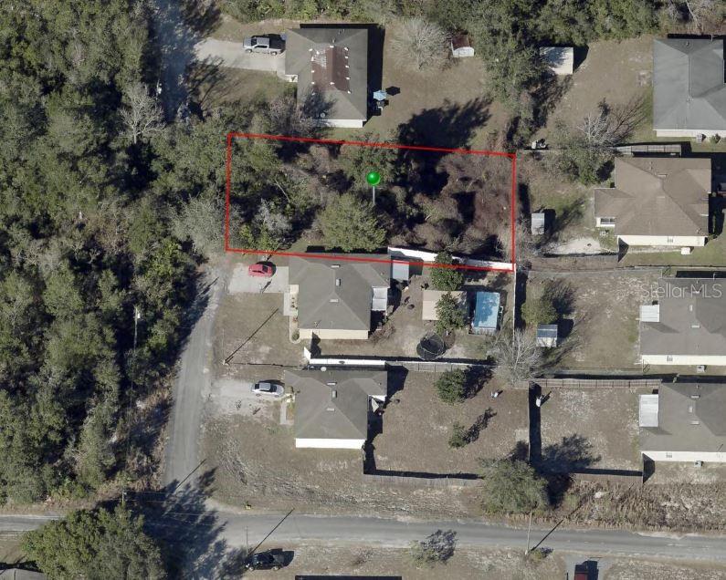 This aerial view shows a rectangular vacant lot outlined in red next to residential houses — CHESTNUT AVENUE, ORANGE CITY, FL