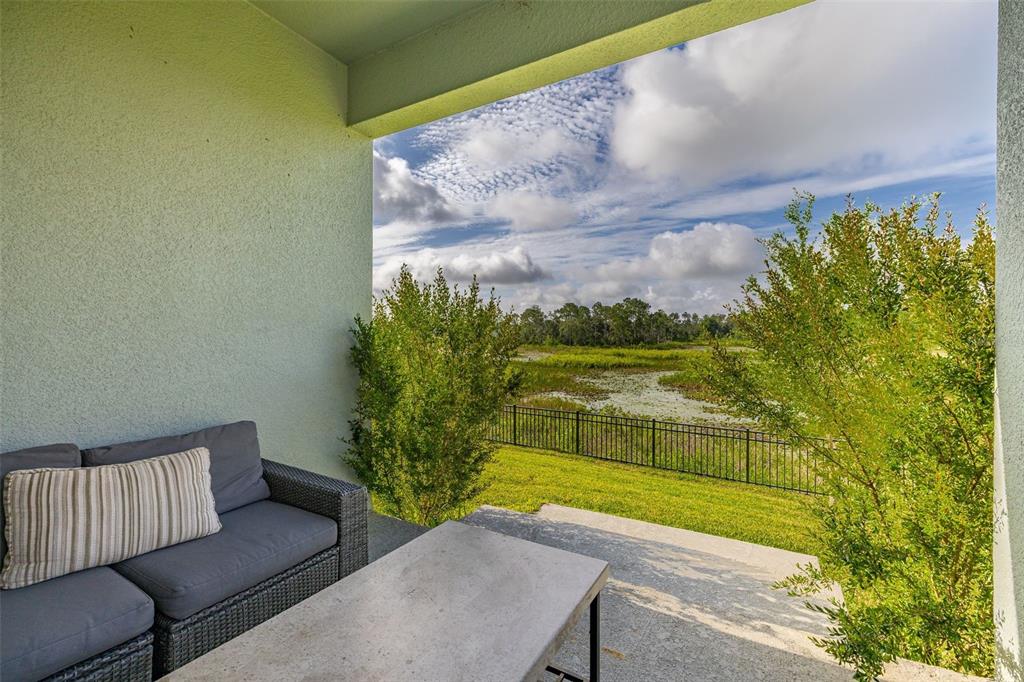 A single-story house with light blue siding, stone veneer, and a front-facing gable roof — 2236 DERWENT DRIVE, DAVENPORT, FL