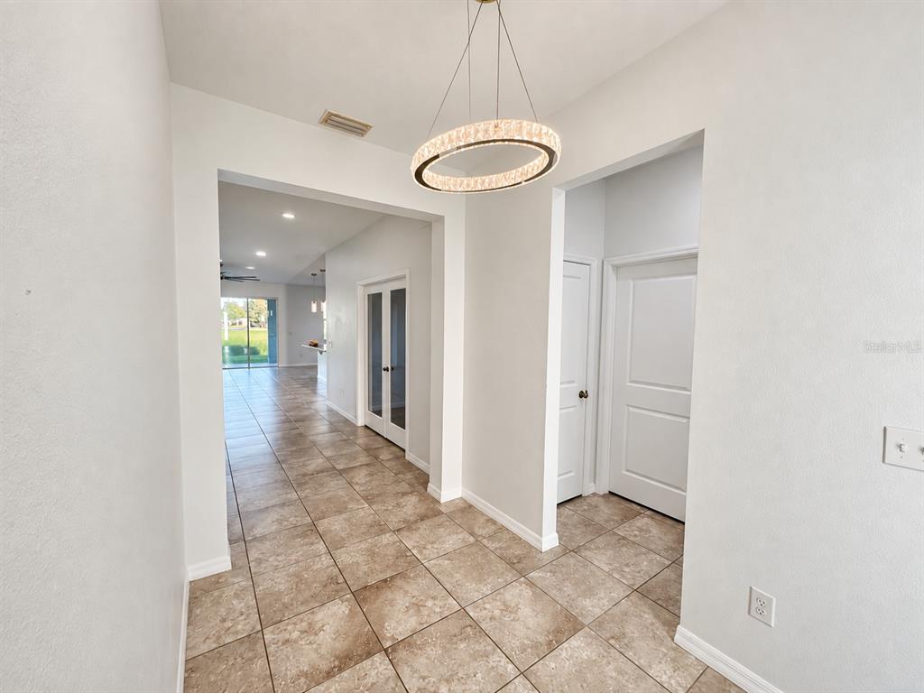 A light blue single-story house with a two-car garage and a large front tree — 5703 SW 50TH AVENUE, OCALA, FL