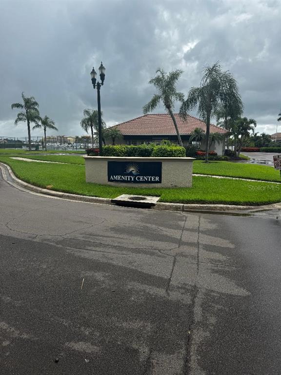 A sign for an amenity center stands in front of a building with palm trees — 1205 3RD ST CIRCLE E, PALMETTO, FL