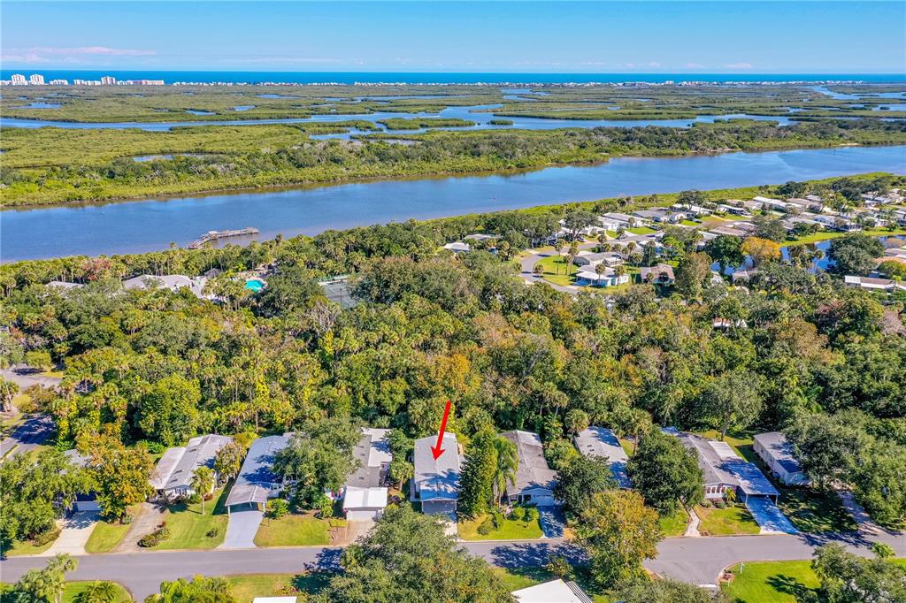 An aerial view shows a single-story house with a red arrow pointing to its roof — 509 STARBOARD AVENUE, EDGEWATER, FL