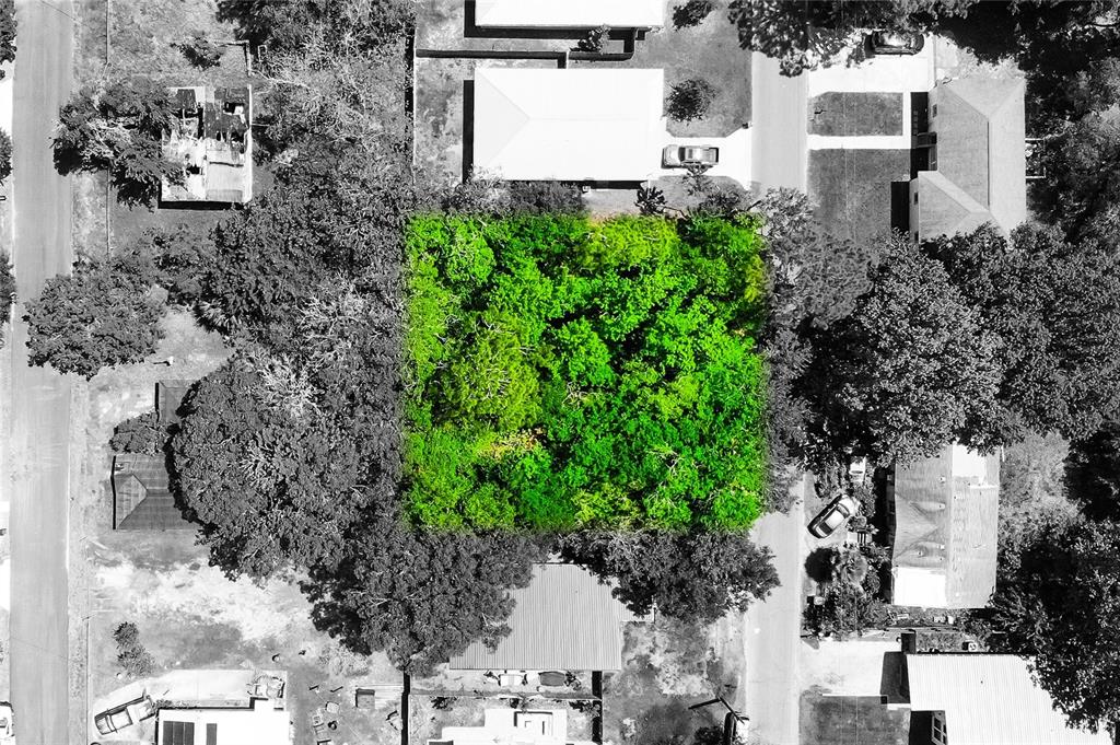 An aerial view shows a rectangular plot of land highlighted in green amidst residential properties — 1028 COLLIER BOULEVARD, ST AUGUSTINE, FL