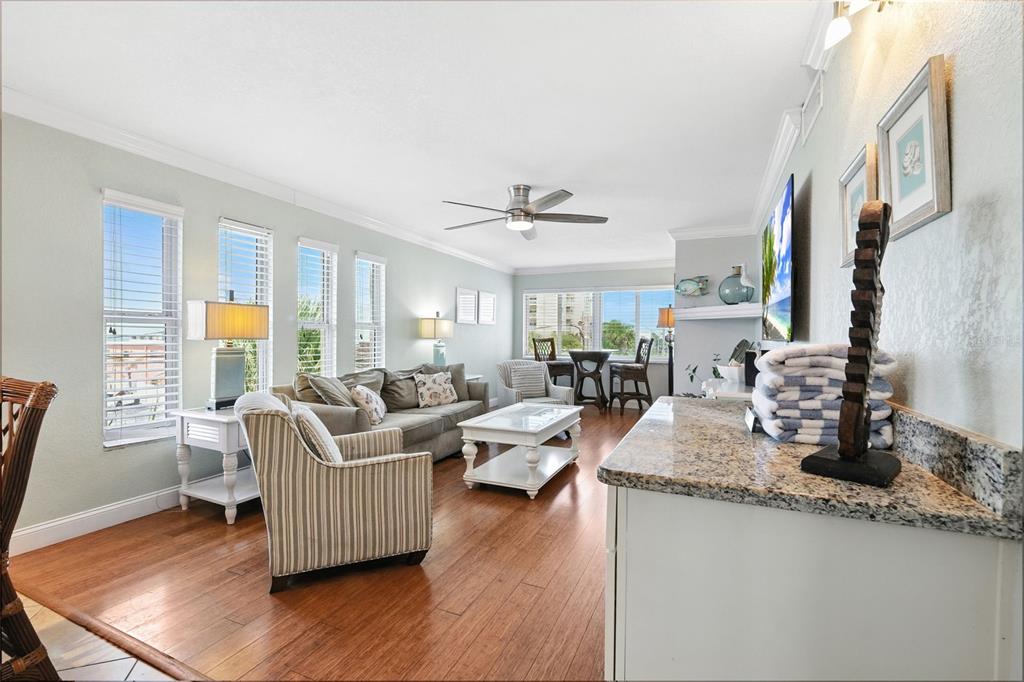 An aerial view shows a coastal apartment complex situated between a waterway and the beach — 10265 GULF BOULEVARD UNIT A-301, ST PETERSBURG, FL