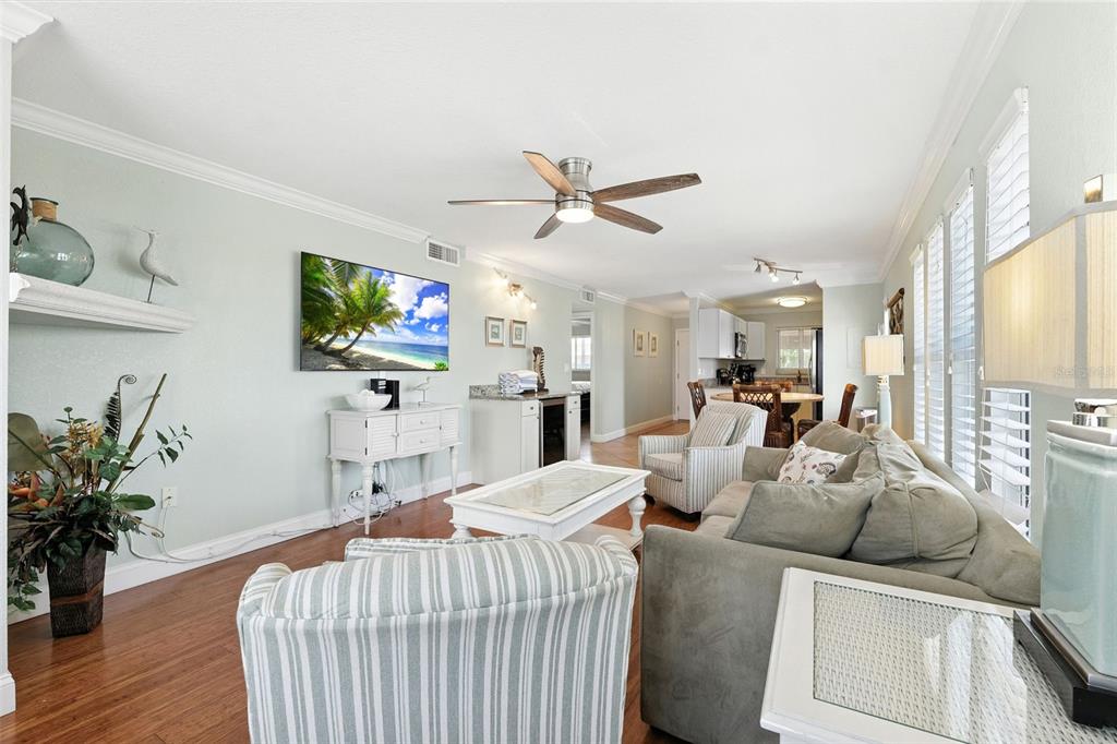 An exterior view of a multi-story apartment building with a pool and private boat docks — 10265 GULF BOULEVARD UNIT A-301, ST PETERSBURG, FL