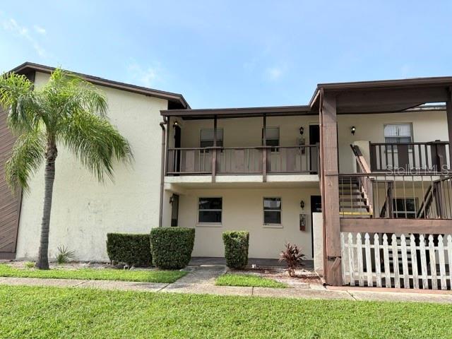 A hallway features white paneled closet doors, light-colored tile flooring, and neutral wall paint — 5521 BAY BOULEVARD UNIT 101, PORT RICHEY, FL