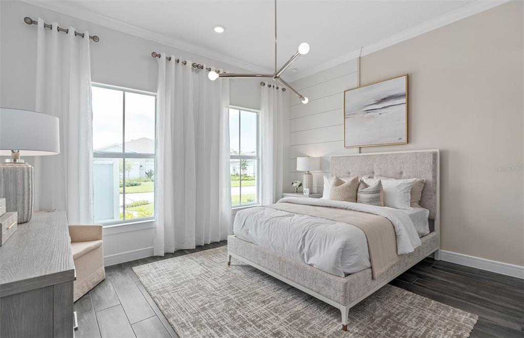 A bedroom features a bed with a tufted headboard, shiplap wall, and a modern chandelier — 15000 CANOPY COVER DRIVE, WINTER GARDEN, FL