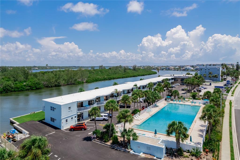 A studio apartment features a bed, a small dining table, a kitchen area, and tiled floors — 18399 GULF BOULEVARD UNIT 371, INDIAN SHORES, FL