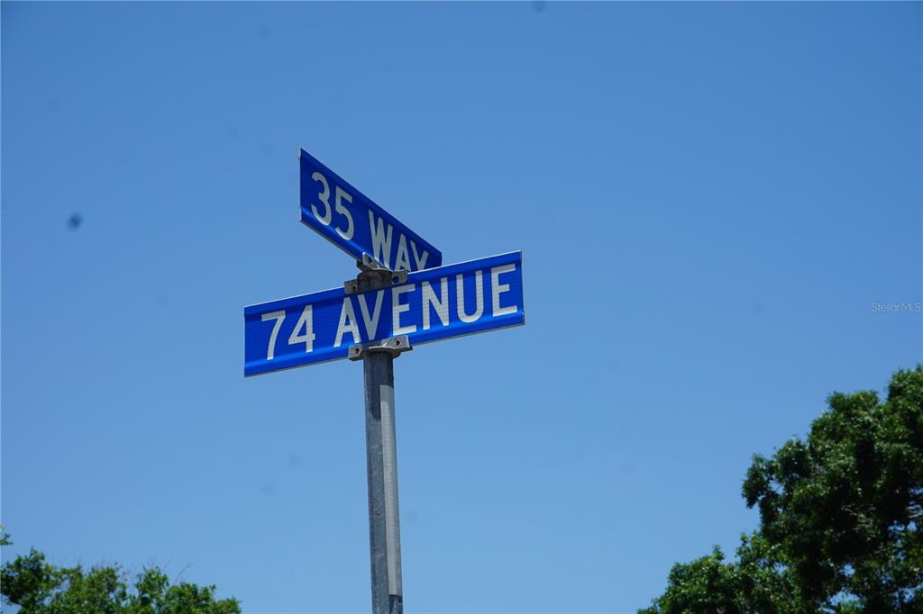 A street sign showing the intersection of 35 Way and 74 Avenue against a blue sky — 0 74TH AVENUE N, PINELLAS PARK, FL