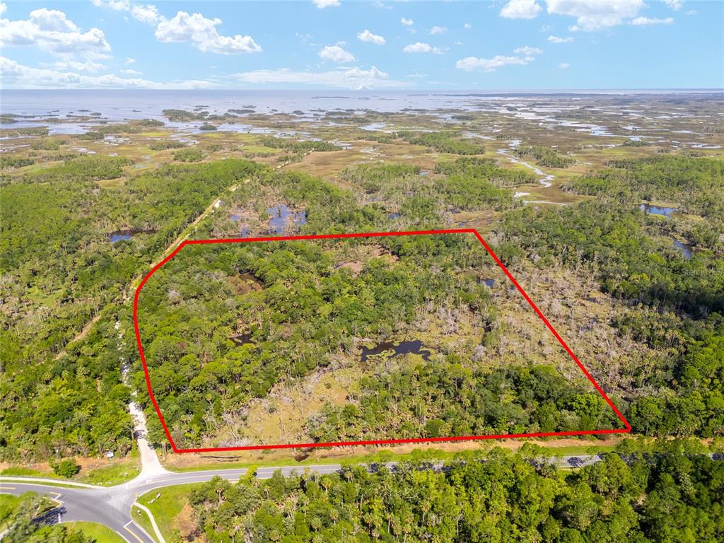 An aerial view shows a rectangular plot of wooded land outlined in red near water — 0 SE 193RD PLACE, YANKEETOWN, FL