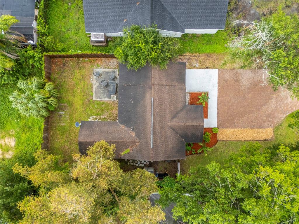 An aerial view shows a house with a brown roof, a patio, and a driveway — 1717 W MOHAWK AVENUE, TAMPA, FL