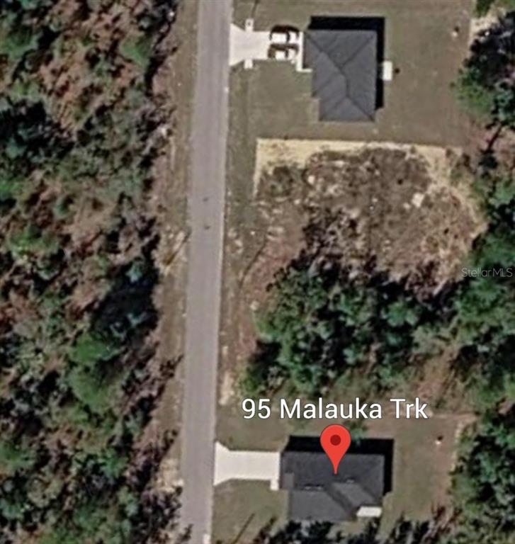 This aerial map view shows two houses situated along a road surrounded by wooded areas — MALAUKA TRAK, OCKLAWAHA, FL
