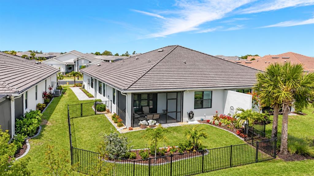 A front exterior view of a house featuring a circled single-car garage and driveway — 18604 DAYSPRING PLACE, VENICE, FL