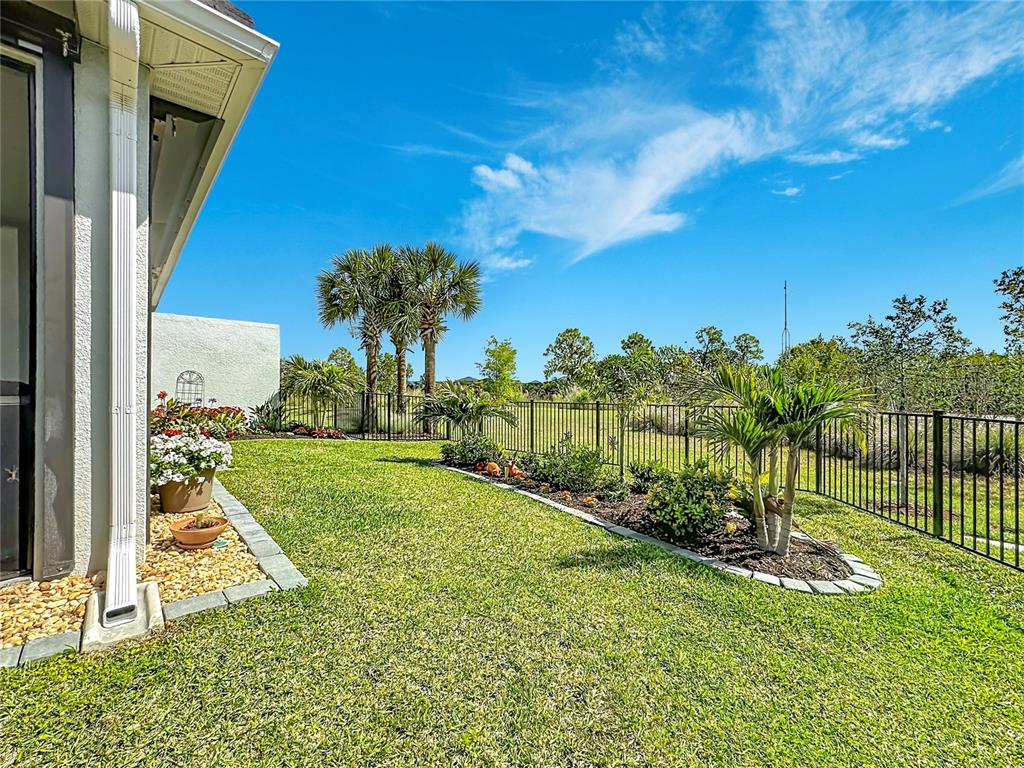 An aerial view shows three suburban houses with gray roofs and paved driveways — 18604 DAYSPRING PLACE, VENICE, FL