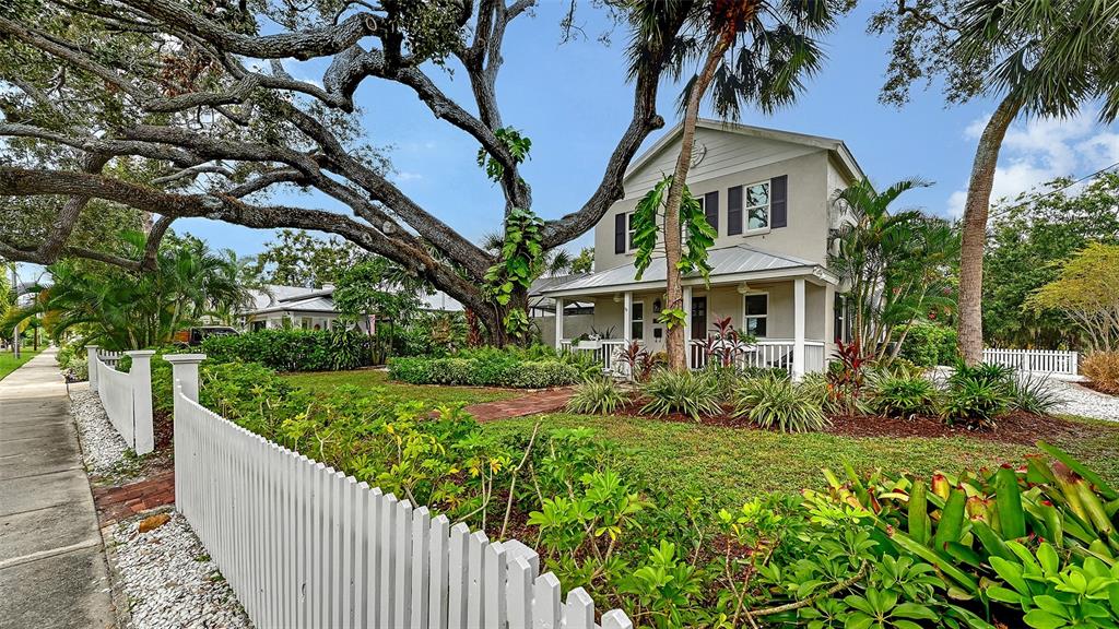 An aerial view of a city skyline with a white circle highlighting a residential house — 1685 6TH STREET, SARASOTA, FL