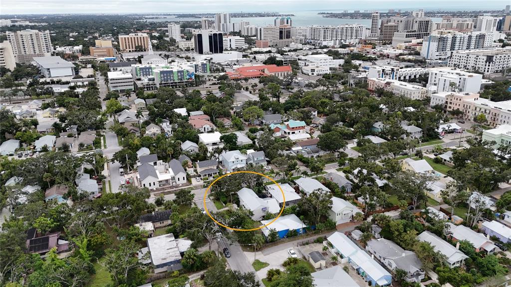 A two-story house with a white picket fence, large oak tree, and landscaped front yard — 1685 6TH STREET, SARASOTA, FL