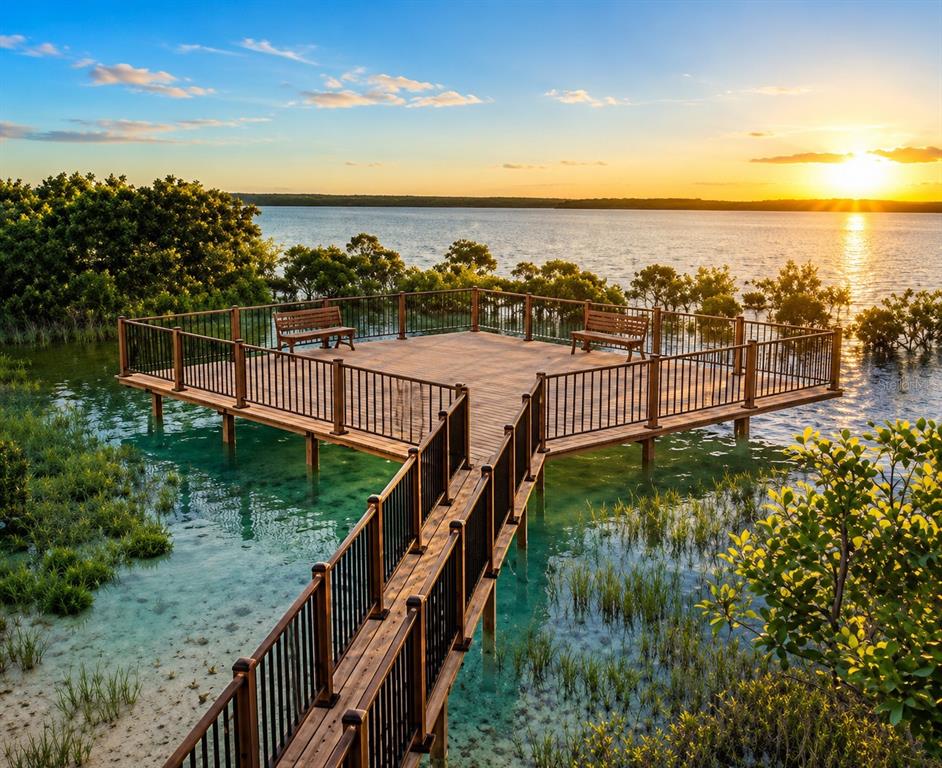 A modern single-story house with a gray garage door and a paved driveway — 8211 37TH AVENUE CIRCLE W, BRADENTON, FL