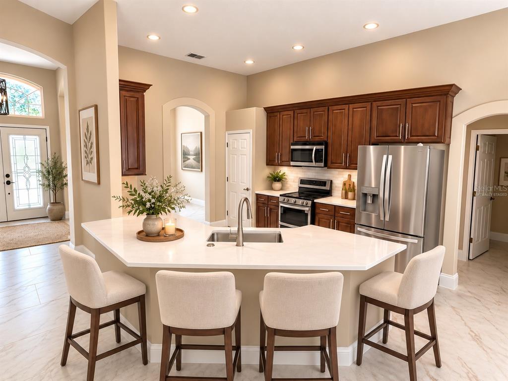 A single-story house with a large front lawn, a prominent tree, and a paved driveway — 2230 RIDGEWIND WAY, WINDERMERE, FL
