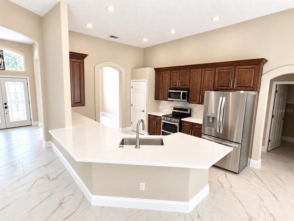 A front entryway features double glass doors, a transom window, and two white columns — 2230 RIDGEWIND WAY, WINDERMERE, FL