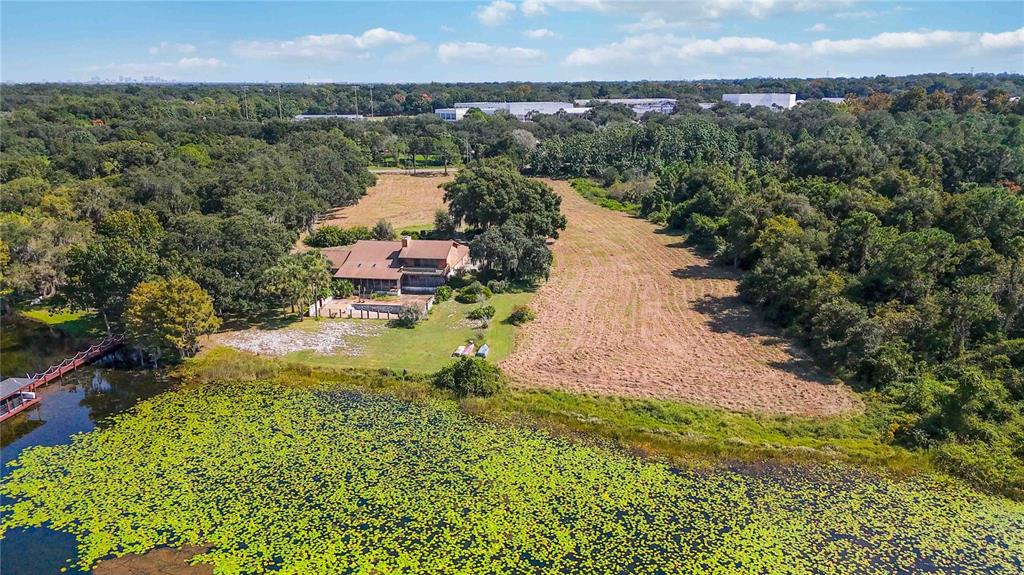 An aerial view shows a house situated on a large lot next to a lake — 4226 DOWNEAST LANE, WINDERMERE, FL
