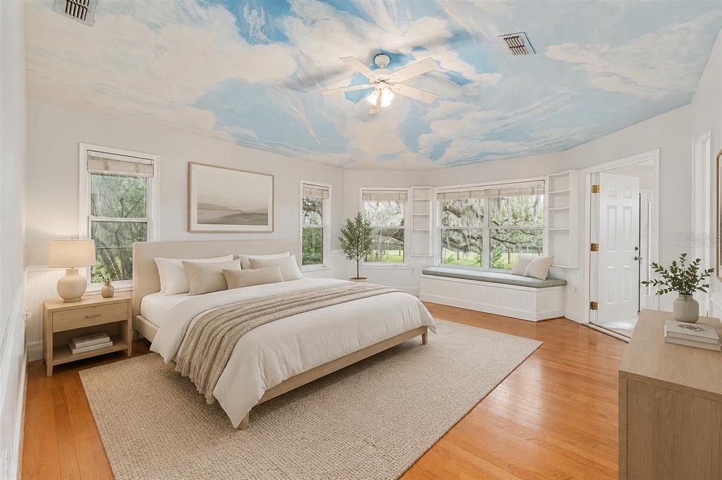 A bedroom with a painted sky ceiling, hardwood floors, and a window seat — 15000 W HWY 318, WILLISTON, FL