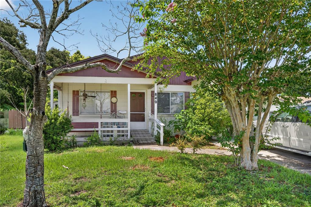 A single-story house with a front porch, a wheelchair ramp, and a large tree — 840 NEUSE AVENUE, ORLANDO, FL