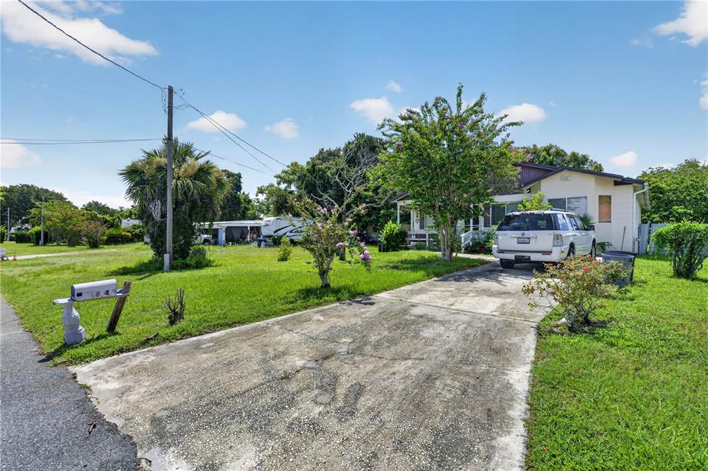 A white SUV is parked on a concrete driveway in front of a single-story house — 840 NEUSE AVENUE, ORLANDO, FL