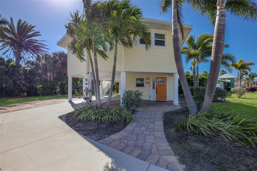 An aerial view shows a canal lined with private boat docks and residential properties — 221 85TH STREET, HOLMES BEACH, FL