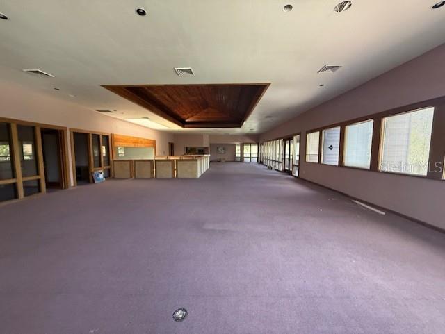 A large, empty room features purple carpeting, a wooden tray ceiling, and a long bar area — 5736 S TEXAS AVENUE, ORLANDO, FL