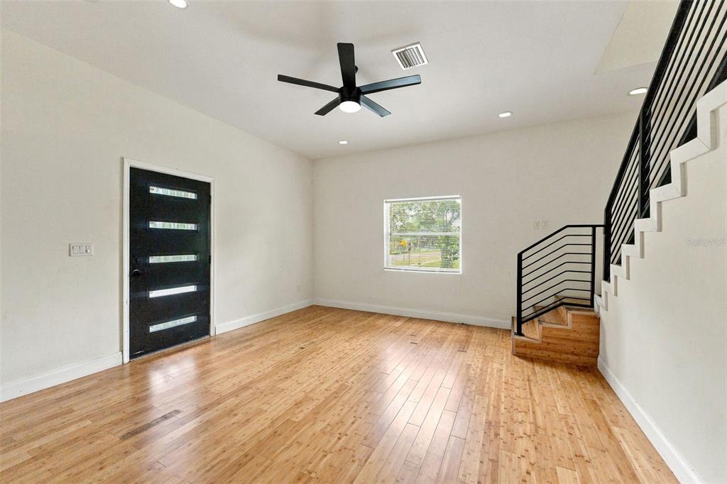 A modern kitchen features black cabinetry, a white quartz island, and stainless steel appliances — 680 25TH AVENUE S, ST PETERSBURG, FL