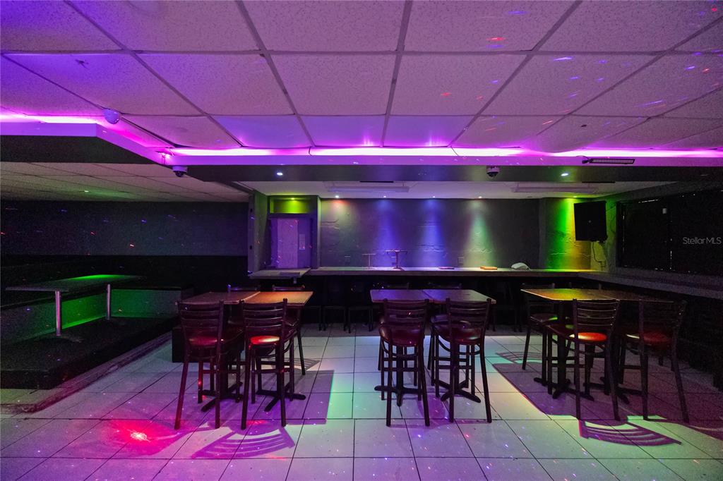 A dimly lit lounge area features tiled floors, bar seating, and vibrant colored accent lighting — 239 ELEANOR ROOSEVELT AVENUE, SAN JUAN, PR