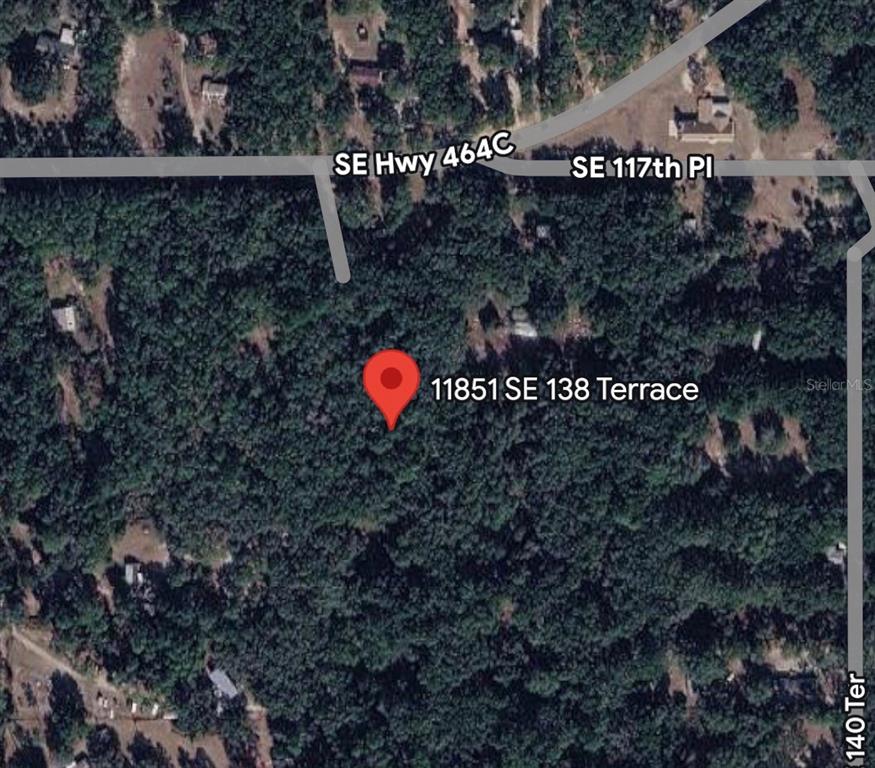 This is a satellite map view showing a wooded lot with a red location pin — 11851 SE 138TH TERRACE, OCKLAWAHA, FL