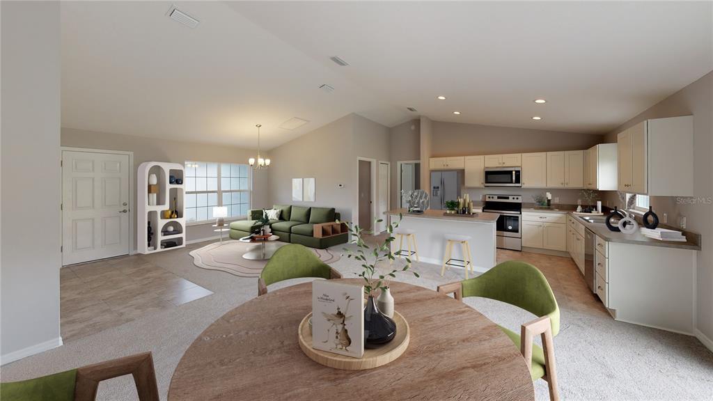An open-concept living area features a kitchen with light cabinets, a dining space, and seating — 1699 NE 161ST STREET, CITRA, FL