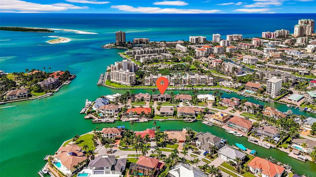 An aerial view shows a waterfront residential neighborhood with a red location pin — 870 PARTRIDGE COURT, MARCO ISLAND, FL