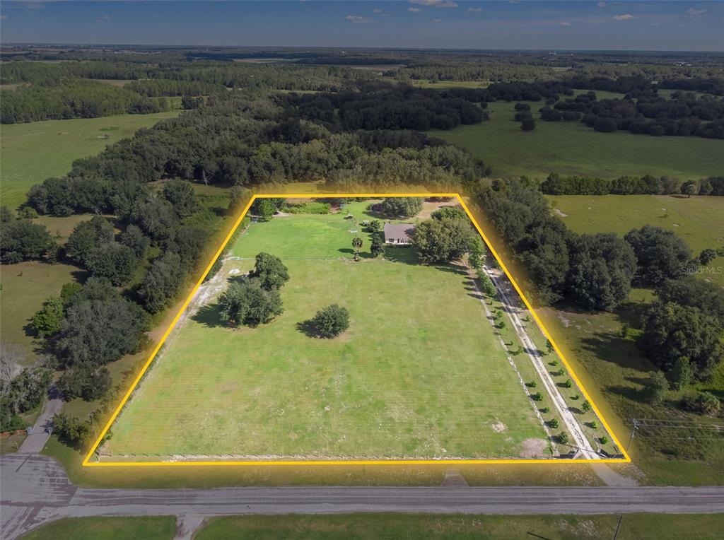 An aerial view shows a house on a large, grassy, rectangular lot with surrounding trees — 2827 HAMMOCK GROVE RD, GROVELAND, FL