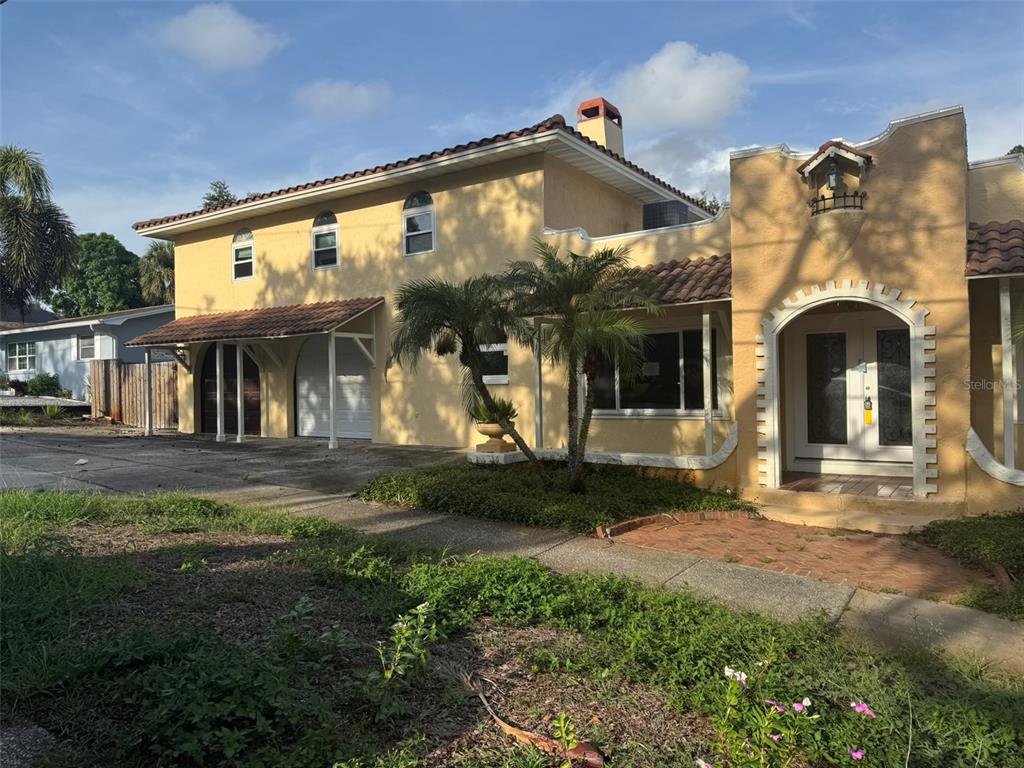 A kitchen features wood cabinets, a dark countertop, a gas stove, and a tiled backsplash — 30 KREAMER AVENUE, TARPON SPRINGS, FL