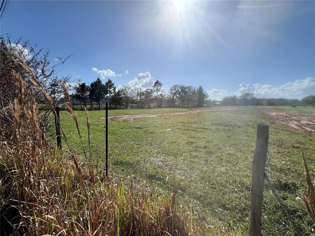 A wide, grassy, fenced-in field under a bright, sunny sky — 0 LA SALLE AVENUE, ST CLOUD, FL