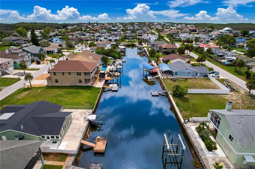 An aerial view of a canal lined with residential houses and private boat docks — 7401 ISLANDER LANE, HUDSON, FL
