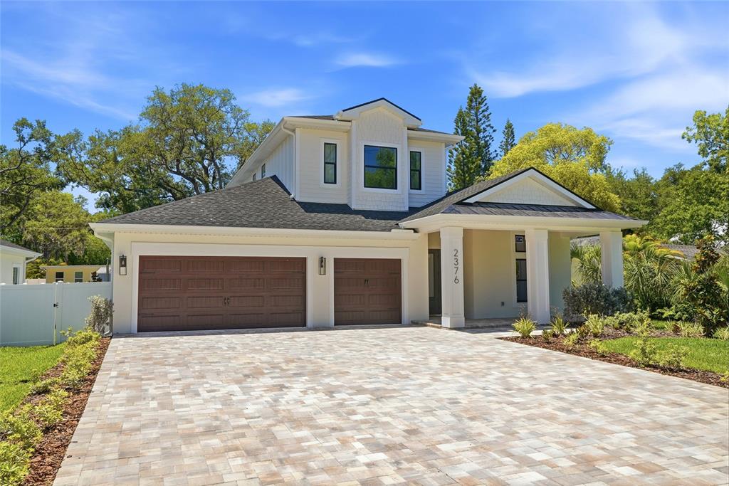 A two-story house with a paved driveway, two-car garage, and a covered front porch — 2376 RAJEL AVENUE, SAFETY HARBOR, FL